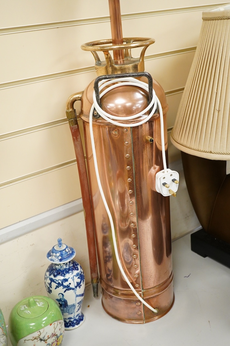 A copper fire extinguisher mounted as a table lamp, overall 93cm high
